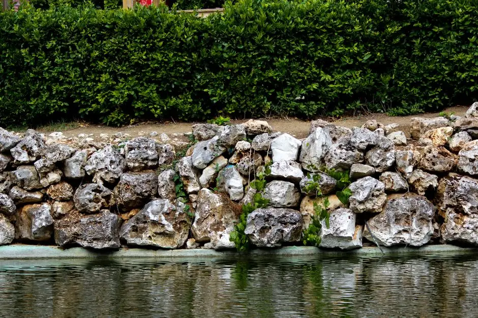 Natural stone retaining wall holding a garden slope